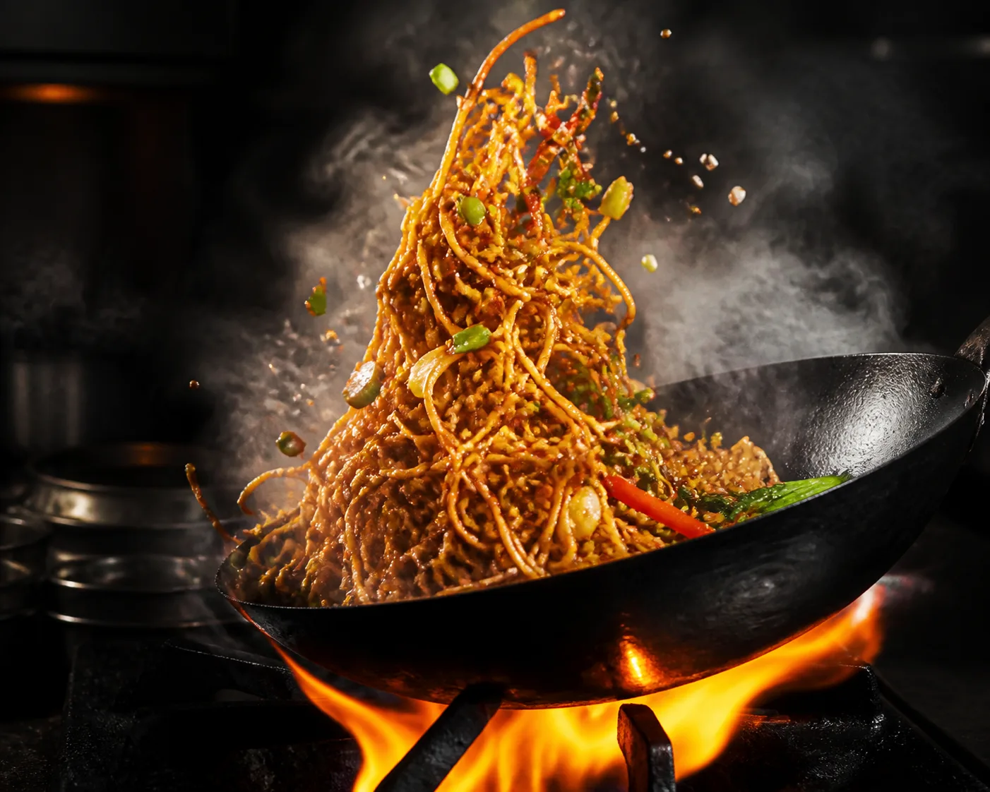 Fire-Tossed Noodles In A Dark Kitchen
