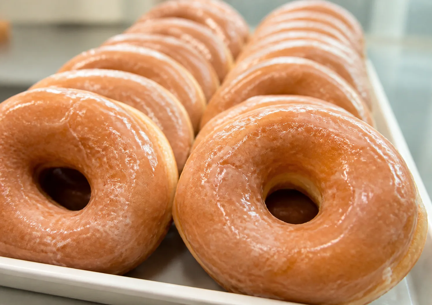 Glossy Glazed Donuts In Shop Tray