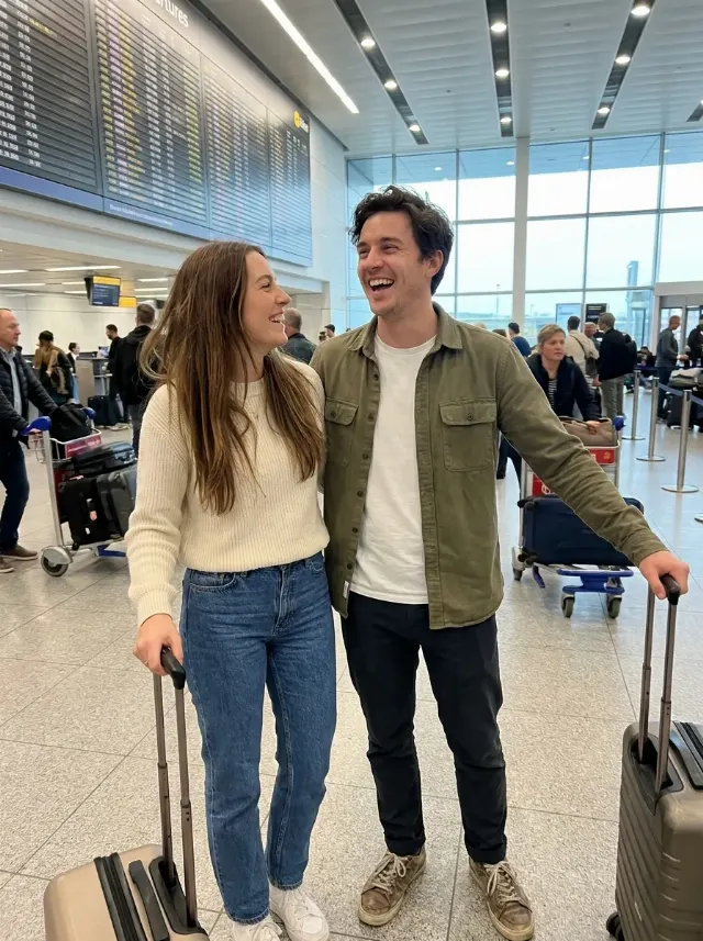 Excited Airport Couple Travel Photo