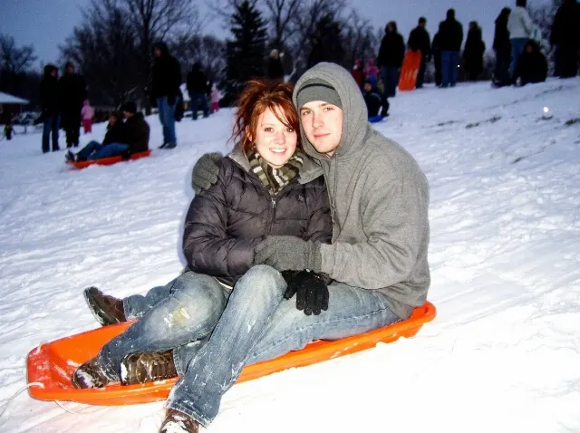 Overexposed 2000s Sledding Couple Photo